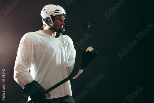 The only goal for was scored by professional ice-hockey player in white uniform and headgear, who is holding hockey stick and tossing a puck in the air