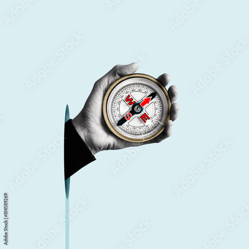 Compass in a humans hand. Business development in the right direction. Art collage.