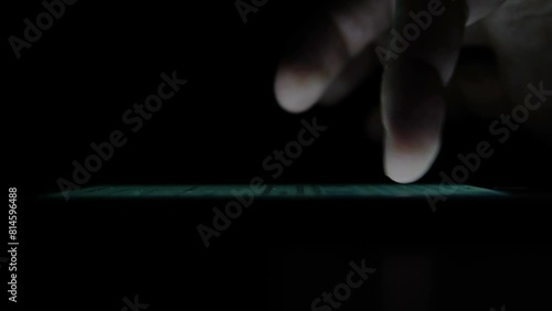 The man's hand enters the Password on the Smart Phone. A man prints a message on the phone. A person prints a Message on the Touch Screen. A man Surfing on the Internet at night. 4K (UHD)