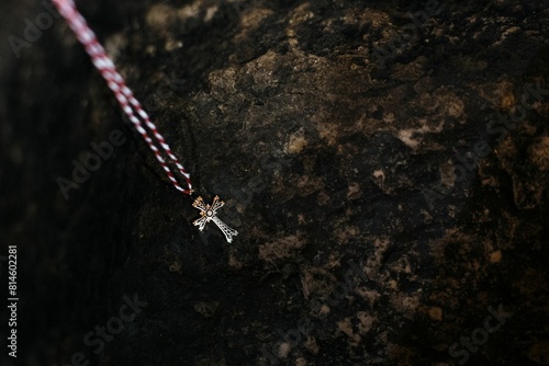 Fotografi Traditional Armenian baptismal cross on a dark rocky surface