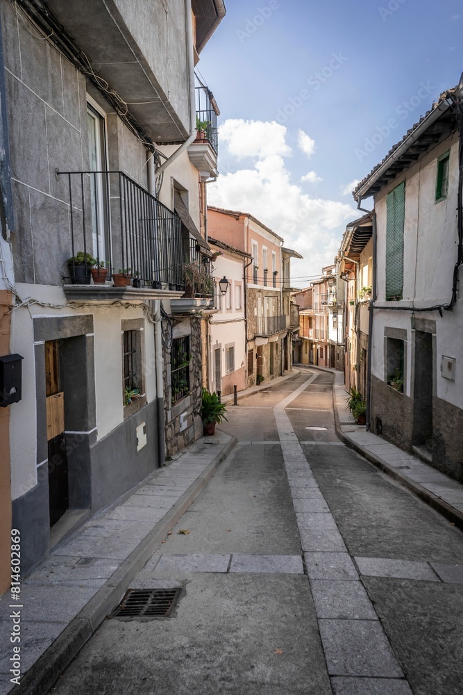 Narrow medieval street with houses close together and stone road, blue sky. Caceres. Extremadura. Narrow medieval street with houses close together and stone road, blue sky. Caceres. Extremadura.