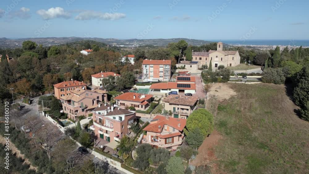 Ascending drone shot of residential buildings and parish church of Saint Stephan in Candelara, Italy Ascending drone shot of residential buildings and parish church of Saint Stephan in Candelara, Italy
