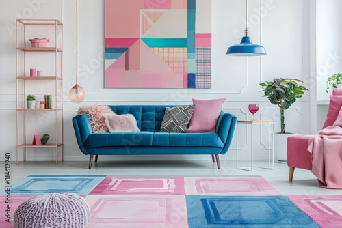 Patterned carpet in pink and blue living room interior with sofa against white wall with painting 