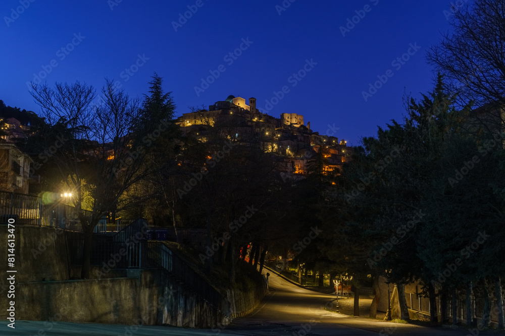 Naklejka premium Night view after sunset at evening twilight of Morano Calabro during blue hour with yellow street lights. Province of Cosenza, Calabria, Italy