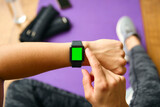 Close Up Of Woman About To Exercise Looking At Green Screen Smart Watch