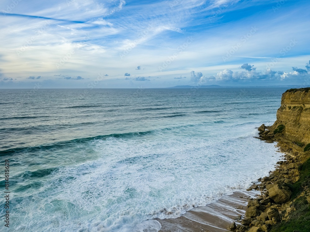 the cliffs overlooking the ocean at sunrise with waves in foreground the cliffs overlooking the ocean at sunrise with waves in foreground