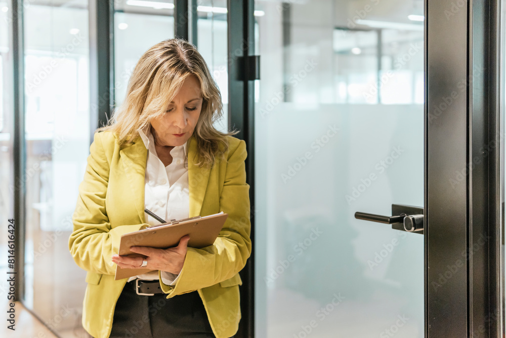 Businesswoman with tablet in a modern coworking space Businesswoman with tablet in a modern coworking space
