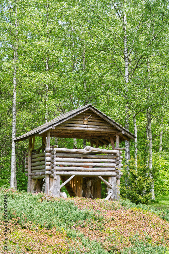 A hunting lodge in nature near a forest and a meadow in the Nordic landscape A hunting lodge in nature near a forest and a meadow in the Nordic landscape