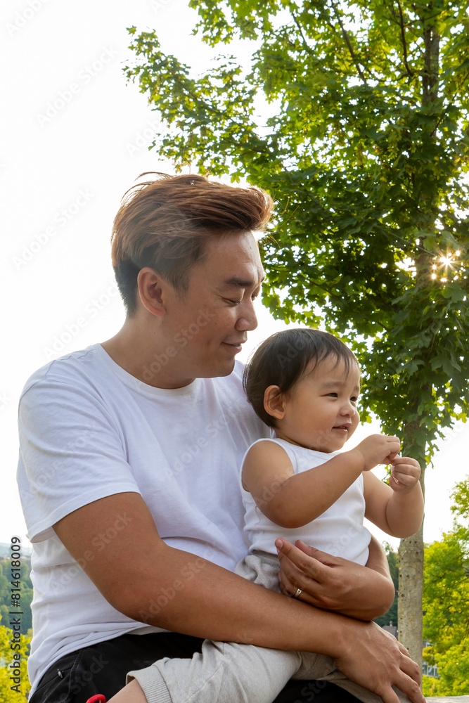 Asian father and child enjoying a European park Asian father and child enjoying a European park