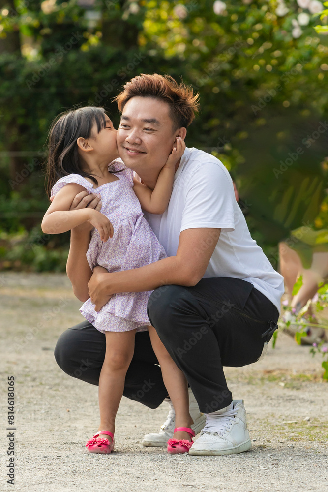 Asian father and daughter sharing a moment on vacation Asian father and daughter sharing a moment on vacation