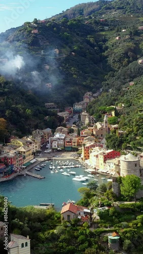 Portofino village coast and green hills on sunny day vertical video.