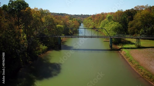 Drone flying over the Little Blue River and a truss bridge on a sunny day in Alton, Indiana. USA photo
