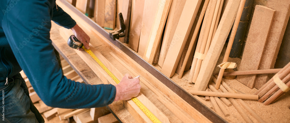 Close Up Of Carpenter Working In Woodwork Workshop Measuring Wood For Project Close Up Of Carpenter Working In Woodwork Workshop Measuring Wood For Project