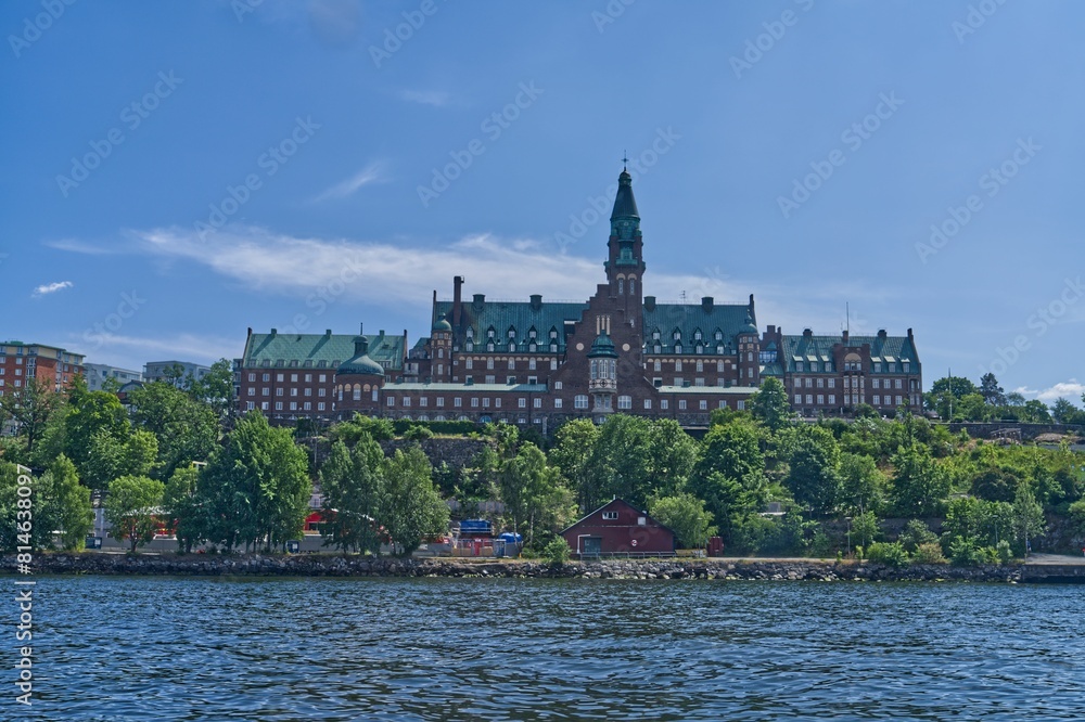 a large building sitting on the top of a mountain over a body of water a large building sitting on the top of a mountain over a body of water
