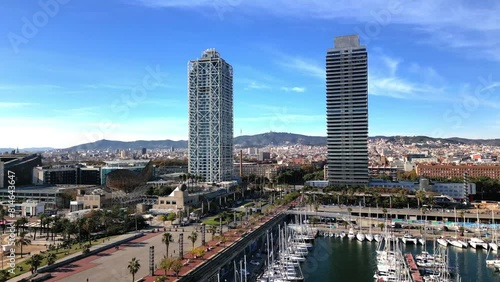 Ascending drone footage of the skyscrapers and Port Olimpic on seafront of Barcelona, Spain