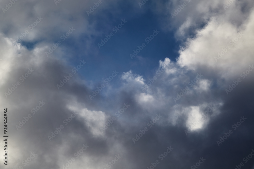 White clouds in the sky and between them you can see the blue sky, clouds high in the sky close-up, view of the sky through the clouds White clouds in the sky and between them you can see the blue sky, clouds high in the sky close-up, view of the sky through the clouds