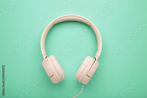 Pink modern headphones on a mint background