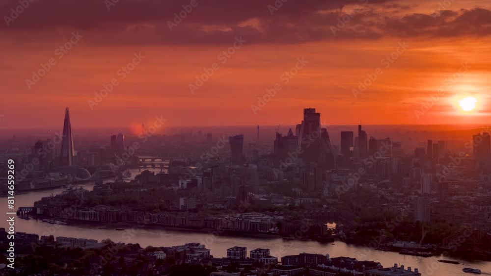 Fiery summer sunset time lapse view of the urban skyline of London, United Kingdom, with red colours and heat haze Fiery summer sunset time lapse view of the urban skyline of London, United Kingdom, with red colours and heat haze