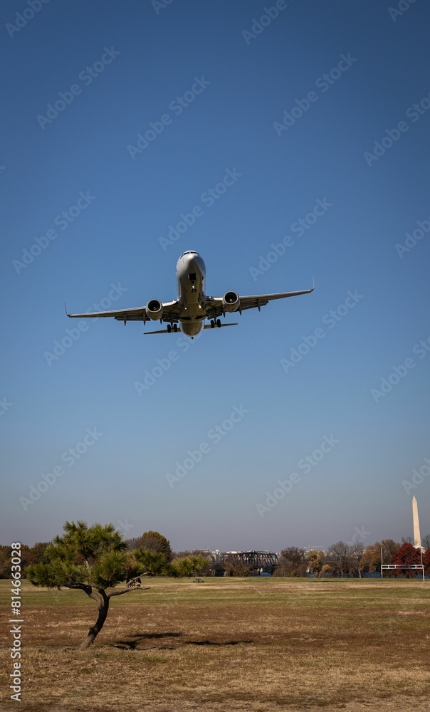 Small commercial airplane flies over a vast expanse of dried, barren terrain in Washington DC Small commercial airplane flies over a vast expanse of dried, barren terrain in Washington DC