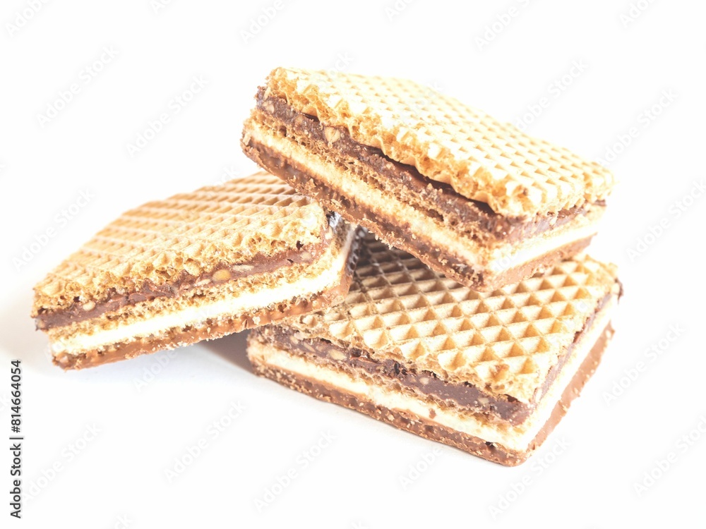 Halves of waffle sandwiches placed on a white background, with the left side of the image in focus Halves of waffle sandwiches placed on a white background, with the left side of the image in focus