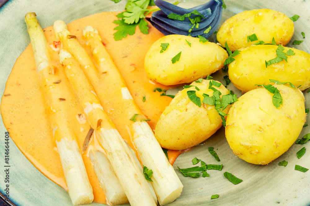 White boiled asparagus in sauce with potato White boiled asparagus in sauce with potato
