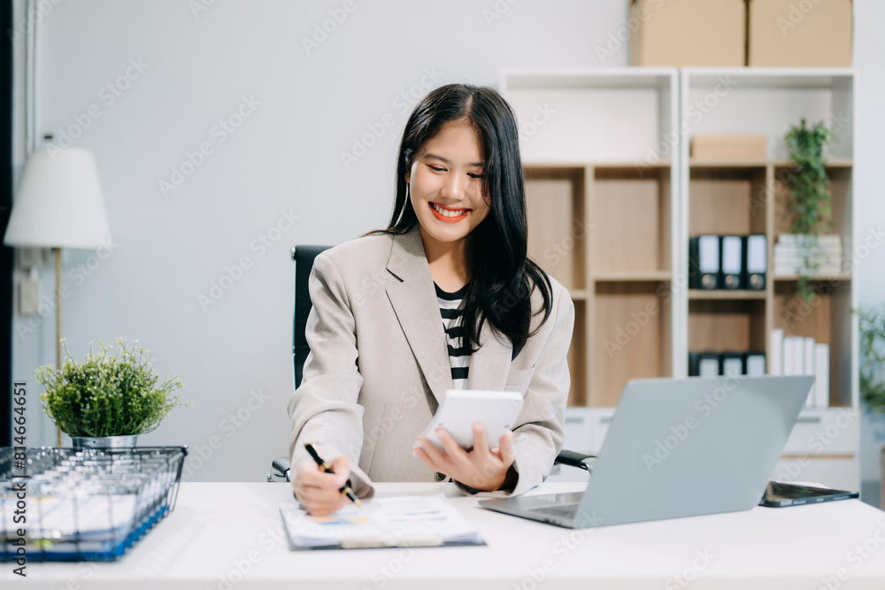 Business woman using tablet and laptop for doing math finance on an office desk, tax Business woman using tablet and laptop for doing math finance on an office desk, tax