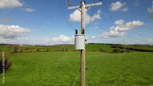 Drone shot circling a 15kVA electricity transformer on an electricity pole in a rural environment