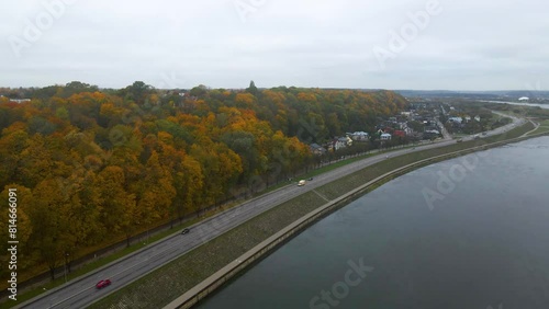 Ascending drone footage of cars driving on Uznemunes G road, and Neman river in Kaunas, Lithuania photo