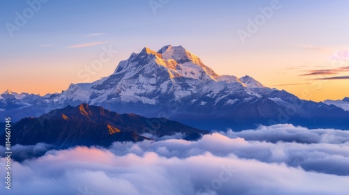 Stunning sunrise over majestic mountain peak surrounded by soft clouds © Yusif