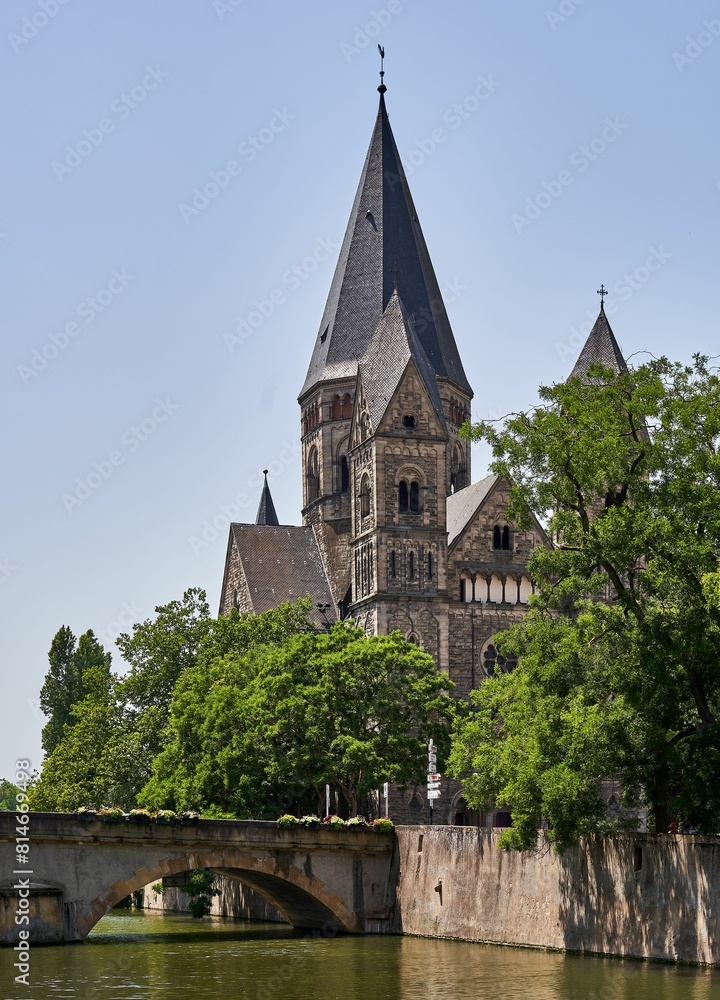 a church steeple sits over a lake next to a bridge a church steeple sits over a lake next to a bridge