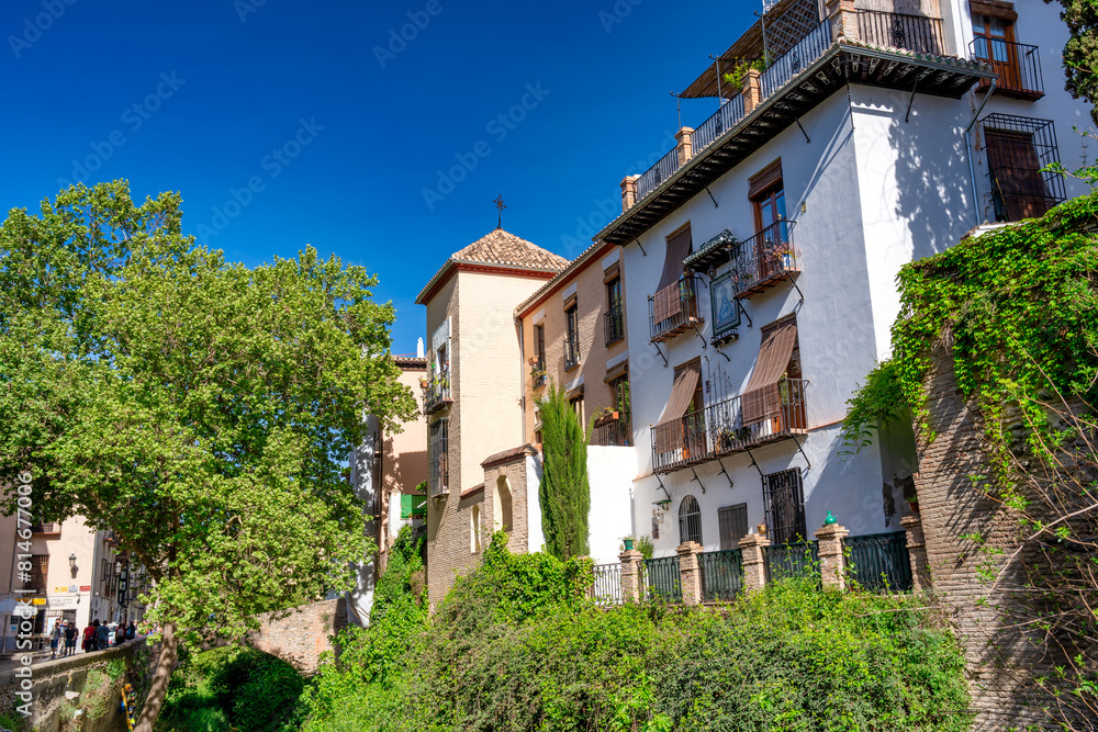 Granada, Spain - April 13, 2023: Tourists along the city streets Granada, Spain - April 13, 2023: Tourists along the city streets
