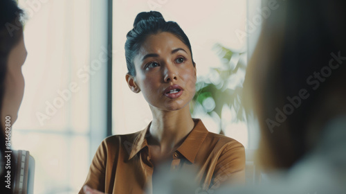 Engaged woman conversing earnestly with unseen peers in a meeting.
