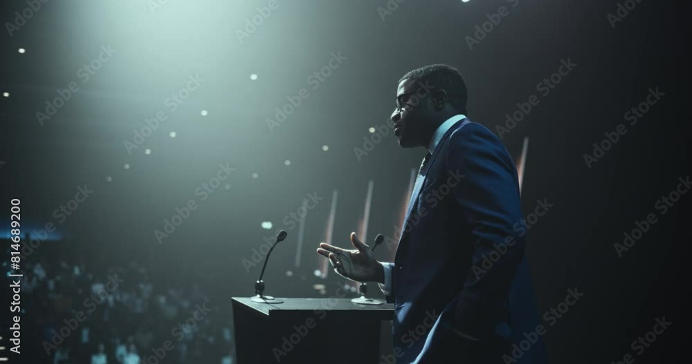 Anonymous Expert Standing Behind a Podium Stand, Giving a Compelling Presentation on Technology, Education and Leadership. Charismatic Black Motivational Speaker Coaching the Audience at a Conference Anonymous Expert Standing Behind a Podium Stand, Giving a Compelling Presentation on Technology, Education and Leadership. Charismatic Black Motivational Speaker Coaching the Audience at a Conference