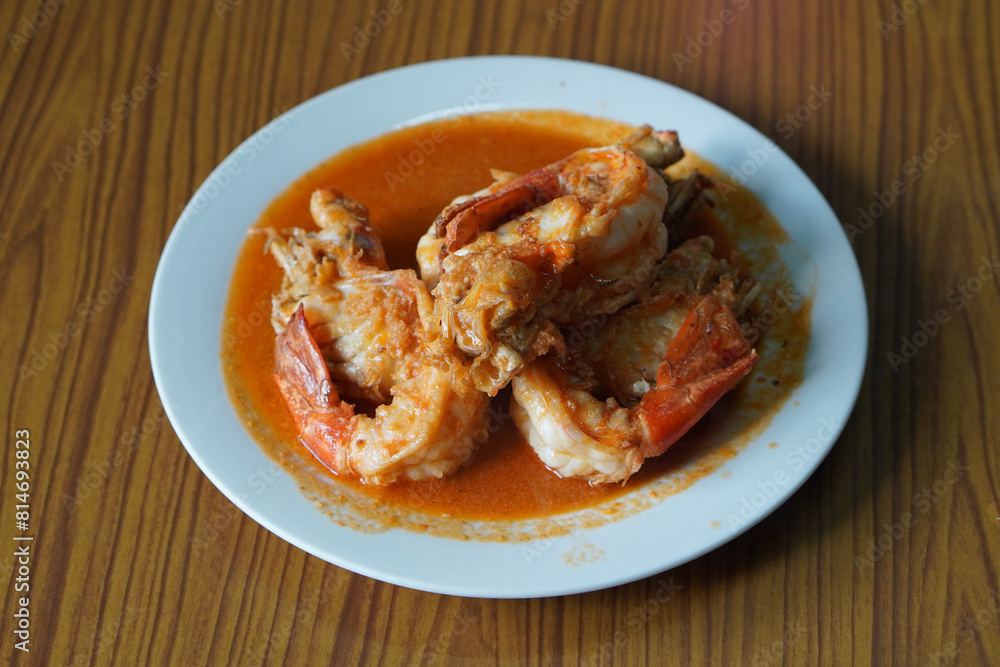 four stir-fried river prawns in a blue plastic plate, on wooden table background, food, animal, copy space four stir-fried river prawns in a blue plastic plate, on wooden table background, food, animal, copy space