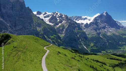 Cinematic drone shot flying over mountain of Grindelwald valley in Switzerland Bernese Alps