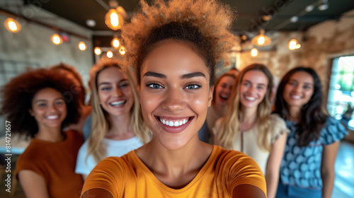 Group of diverse women taking a selfie in a cozy cafe.