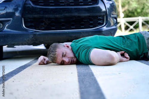 Young man hit by car on a pedestrian crossing, dangerous situation on road 
