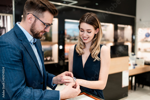 Beautiful couple enjoying in shopping at modern jewelry store. Men fashion and elegance concept.