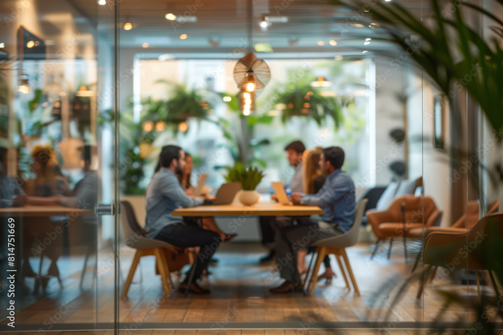 Modern Office Space with Employees in a Team Meeting Through Glass Walls Modern Office Space with Employees in a Team Meeting Through Glass Walls