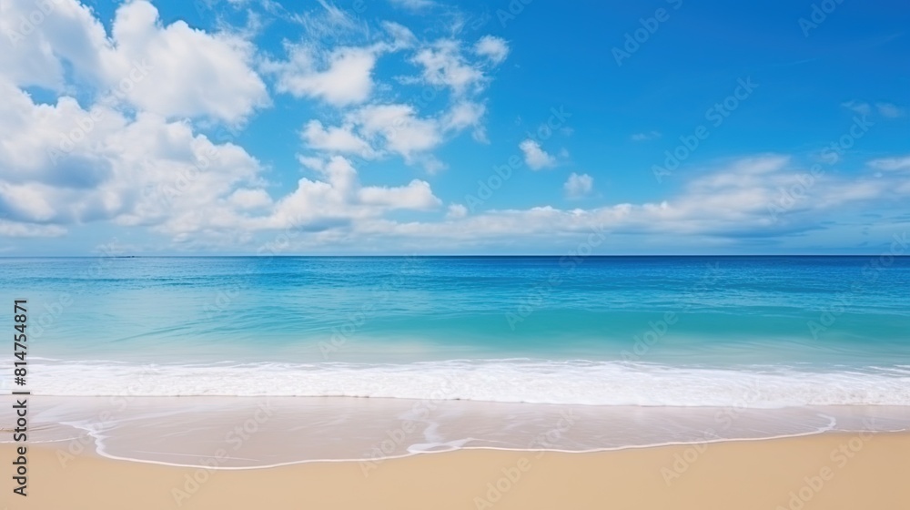 A wide panorama of a serene beach with glistening sand, gentle ocean waves, and a beautiful blue sky.
