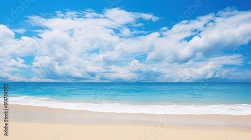 A wide panorama of a serene beach with glistening sand  gentle ocean waves  and a beautiful blue sky.