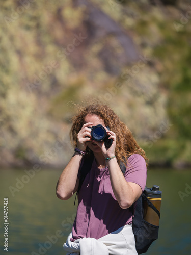 Young Woman Photographer Capturing Nature with DSLR Camera Outdoors photo