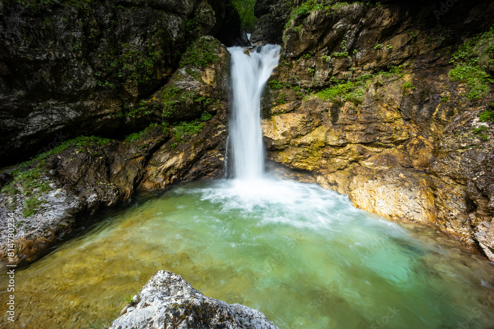 Naklejka premium Rio di Repepeit. Wonderful waterfall that falls from a cliff. The force of the waterfall is a sight to behold. Hiking, trekking in the open area surrounded by woods. Summer holidays, peace.