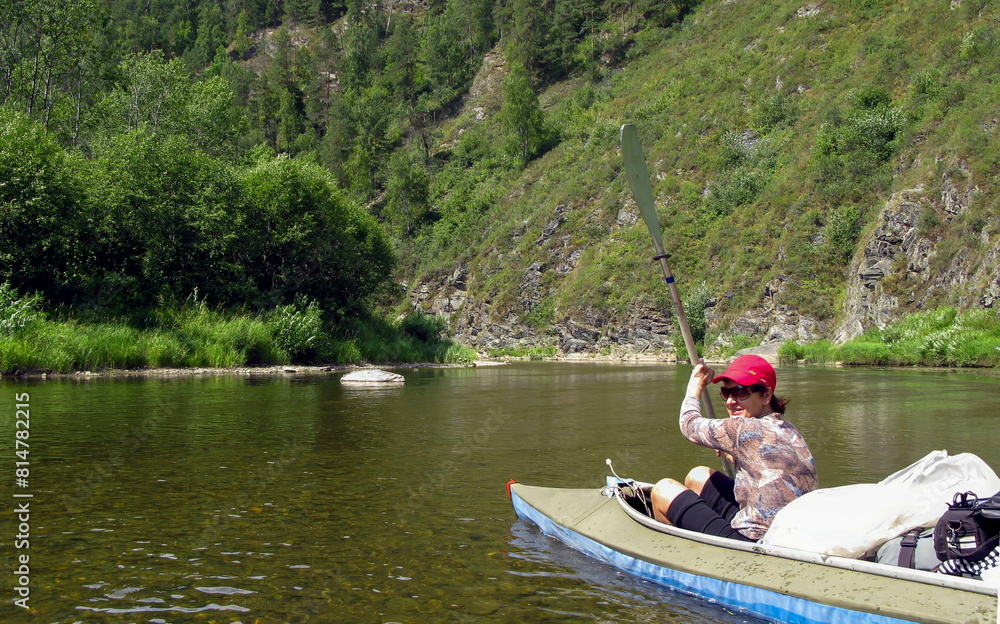 beautiful woman Tourist kayaking on the White River in the Southern Urals in the Republic of Bashkortostan beautiful woman Tourist kayaking on the White River in the Southern Urals in the Republic of Bashkortostan