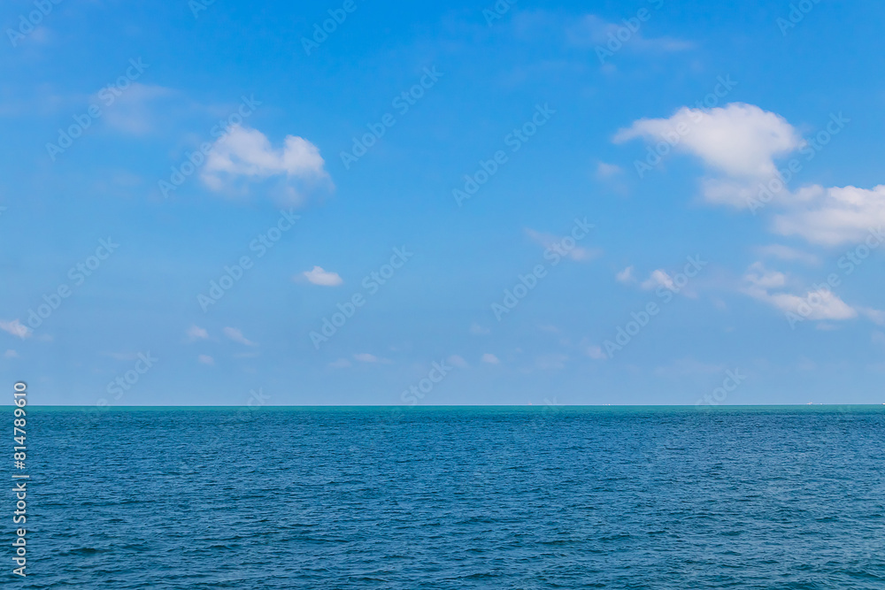 Blue sky with white clouds and the ocean deep indigo in daylight. Blue sky with white clouds and the ocean deep indigo in daylight.