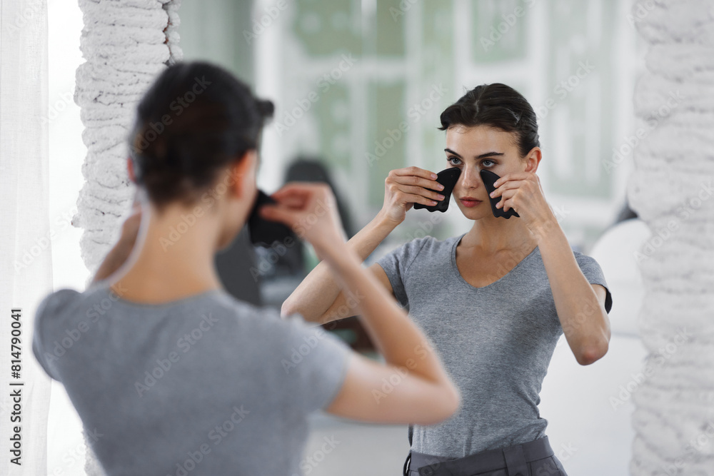 Facial skin care. A woman is doing a face massage using gouache stones. Facial skin care. A woman is doing a face massage using gouache stones.