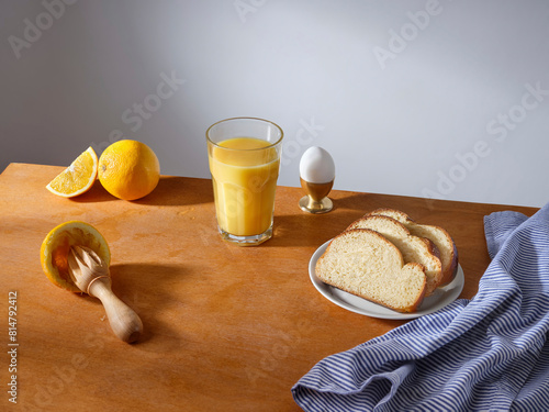 Breakfast with a glass of fresh-pressed orange juice and some slices of brioche bread photo