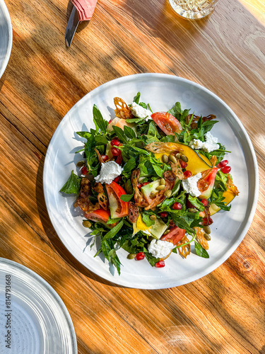 A Salad of Pickled Pumpkin Strips served with Sri Lankan Salad Leaves and Herbs photo