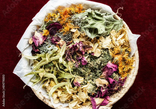 Various dried medicinal herbs in a basket photo