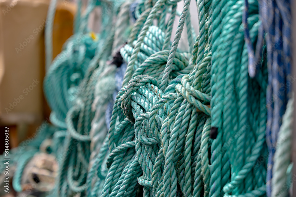 Green ropes coiled on harbor dock